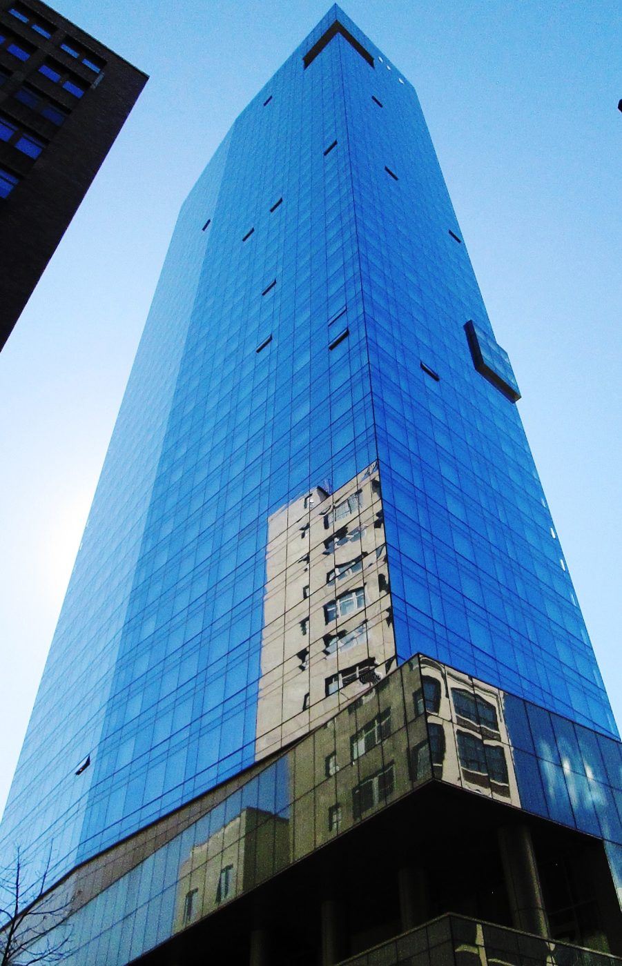 The glass tower at 246 Spring Street in SoHo, Manhattan, built as Trump SoHo and now the Dominick hotel
