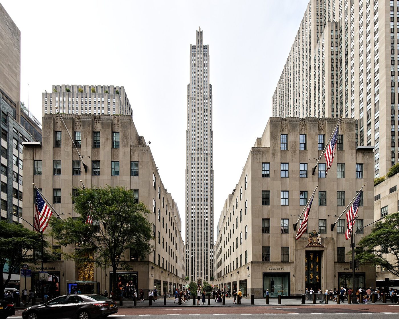 30 Rockefeller Plaza rising between two low buildings seen from Fifth Avenue