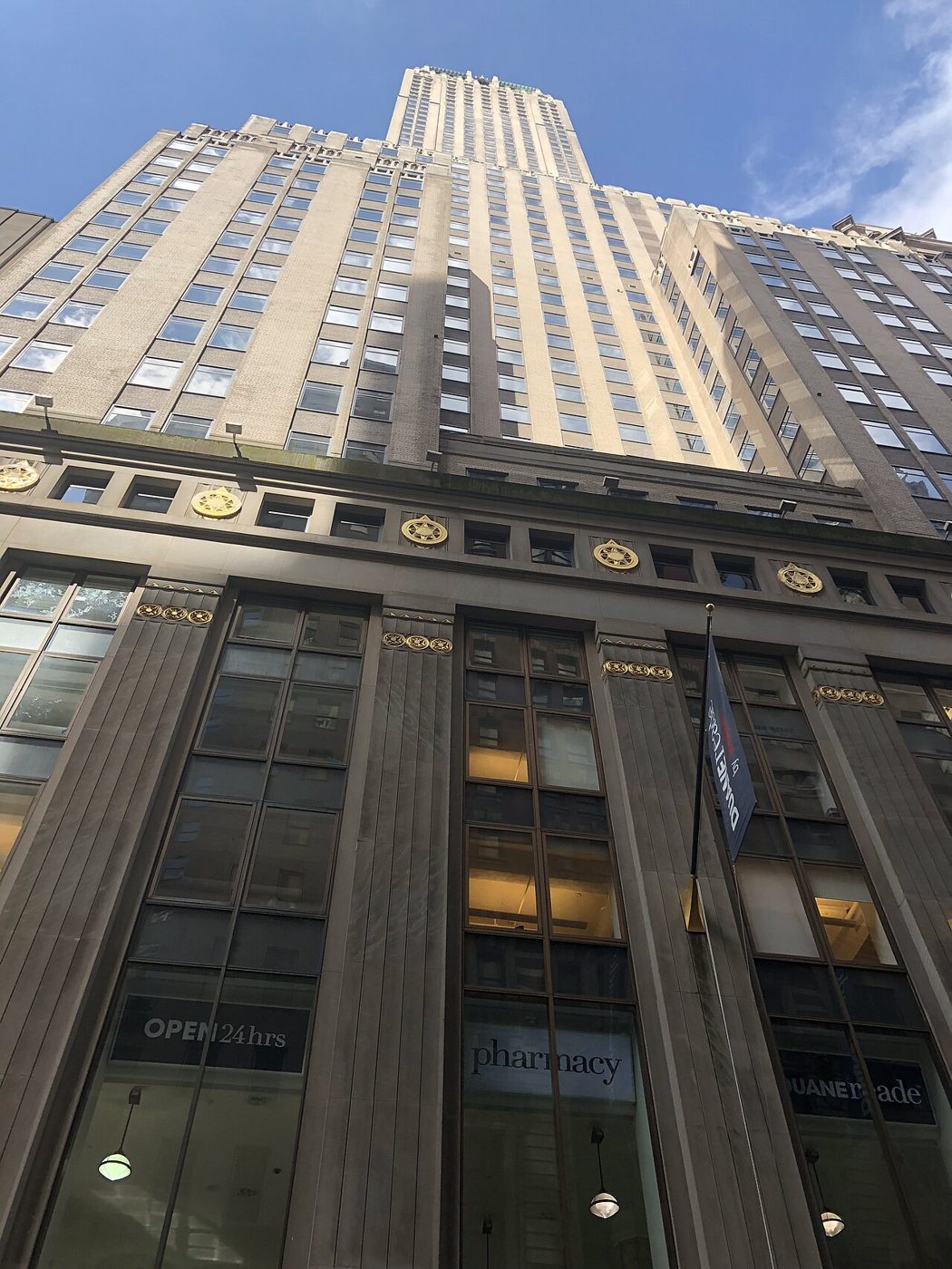 Looking up the facade of the Trump Building at 40 Wall Street toward its tower and pyramidal roof
