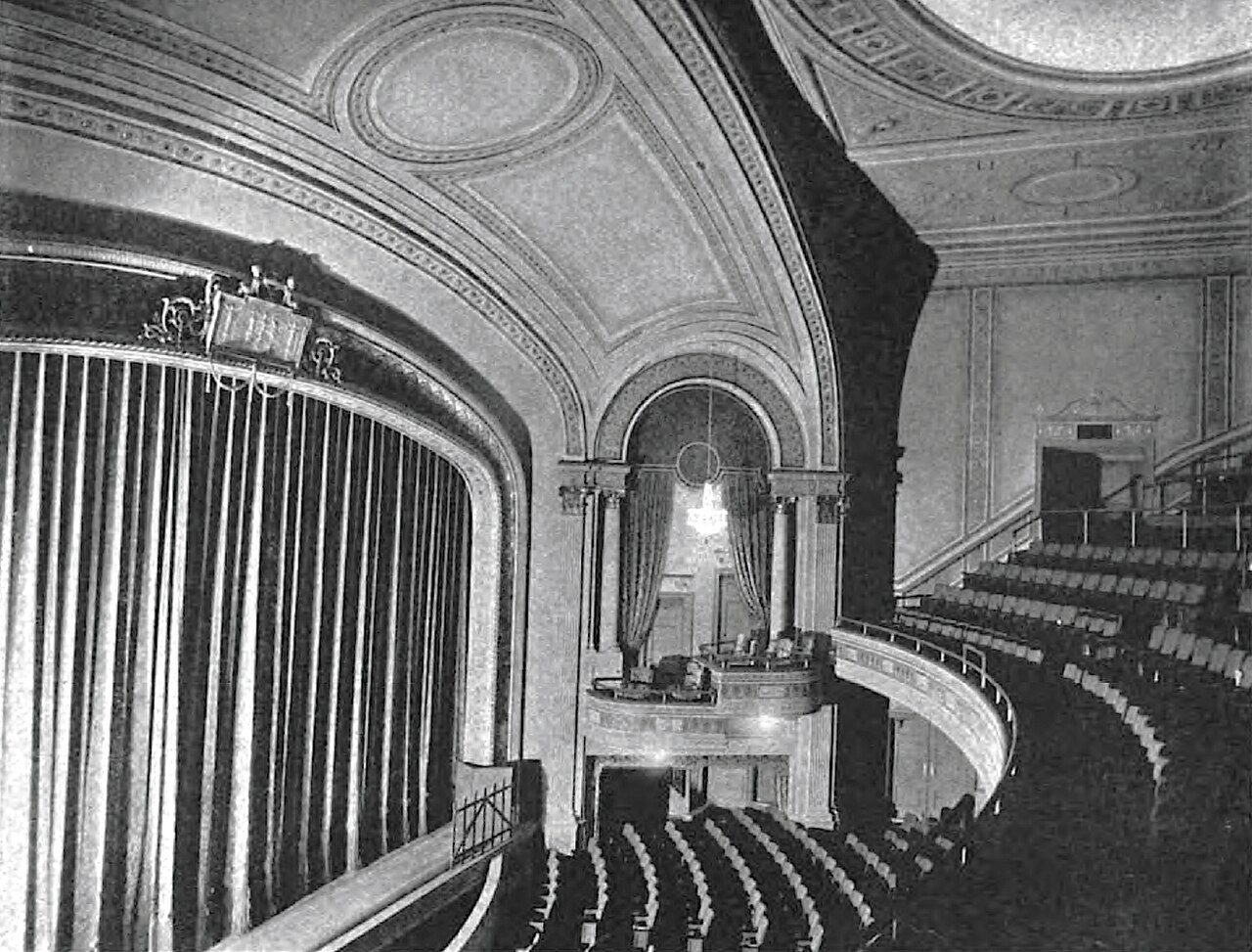 Side view of the interior of the Apollo Theatre on 42nd Street in Manhattan showing the stage curtain and balcony, historic photograph