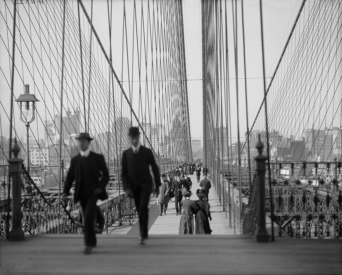 Pedestrians on the Brooklyn Bridge promenade in the early 1900s