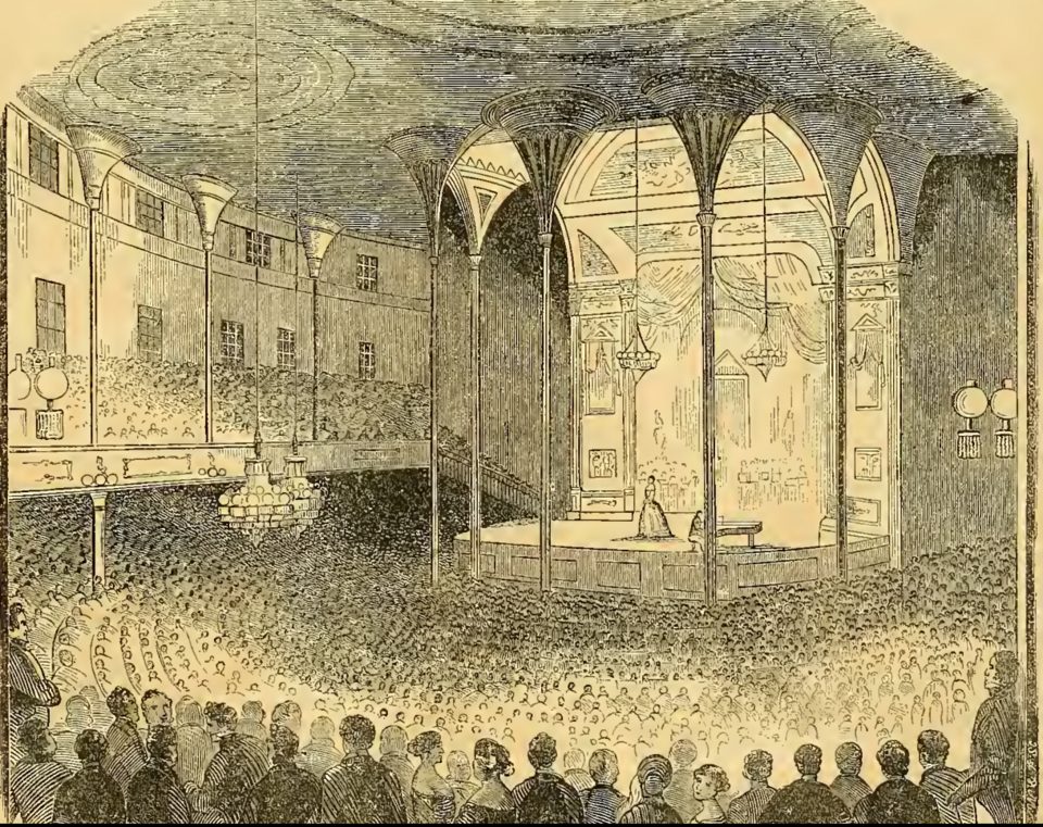 Engraving of the crowded interior of Castle Garden during a Jenny Lind concert, with a domed ceiling and a packed audience