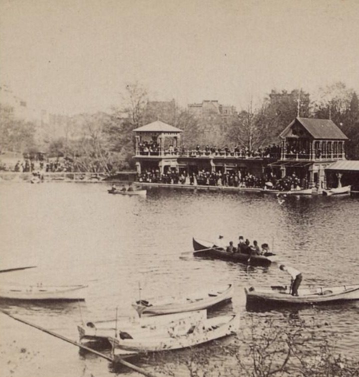 Black and white stereoscopic photograph of a boathouse on the shore of the Lake with rowboats in the water