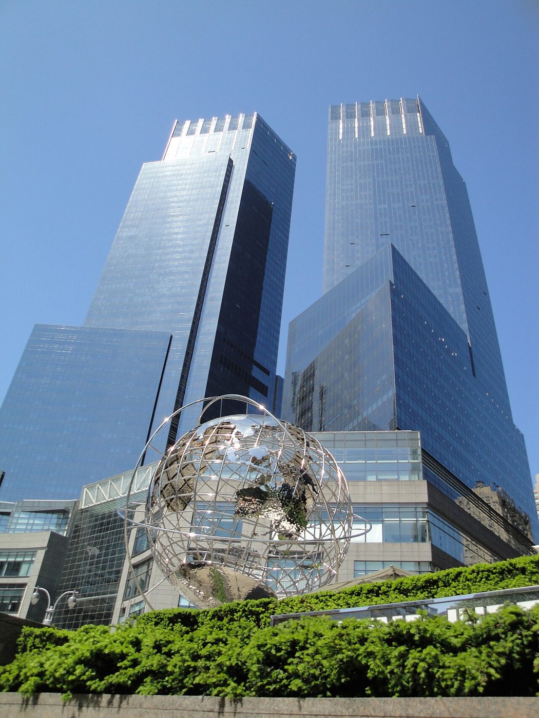 The stainless-steel globe at Columbus Circle in front of the glass towers of the Time Warner Center