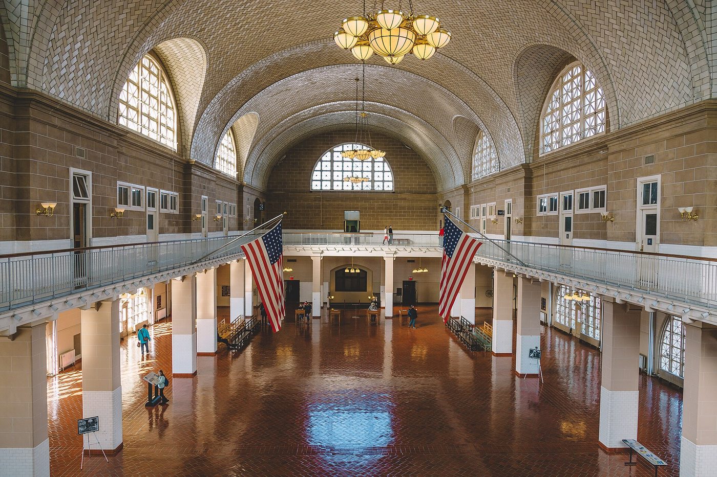 The Registry Room on Ellis Island, with its tiled vaulted ceiling, balcony and red tile floor