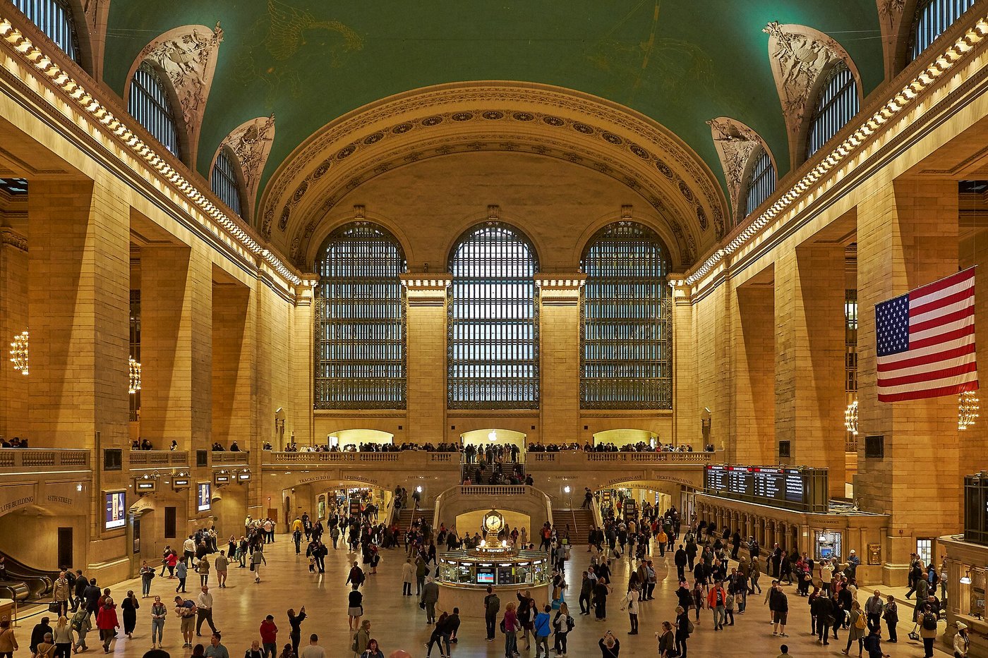The Main Concourse of Grand Central Terminal with its painted ceiling and arched windows.
