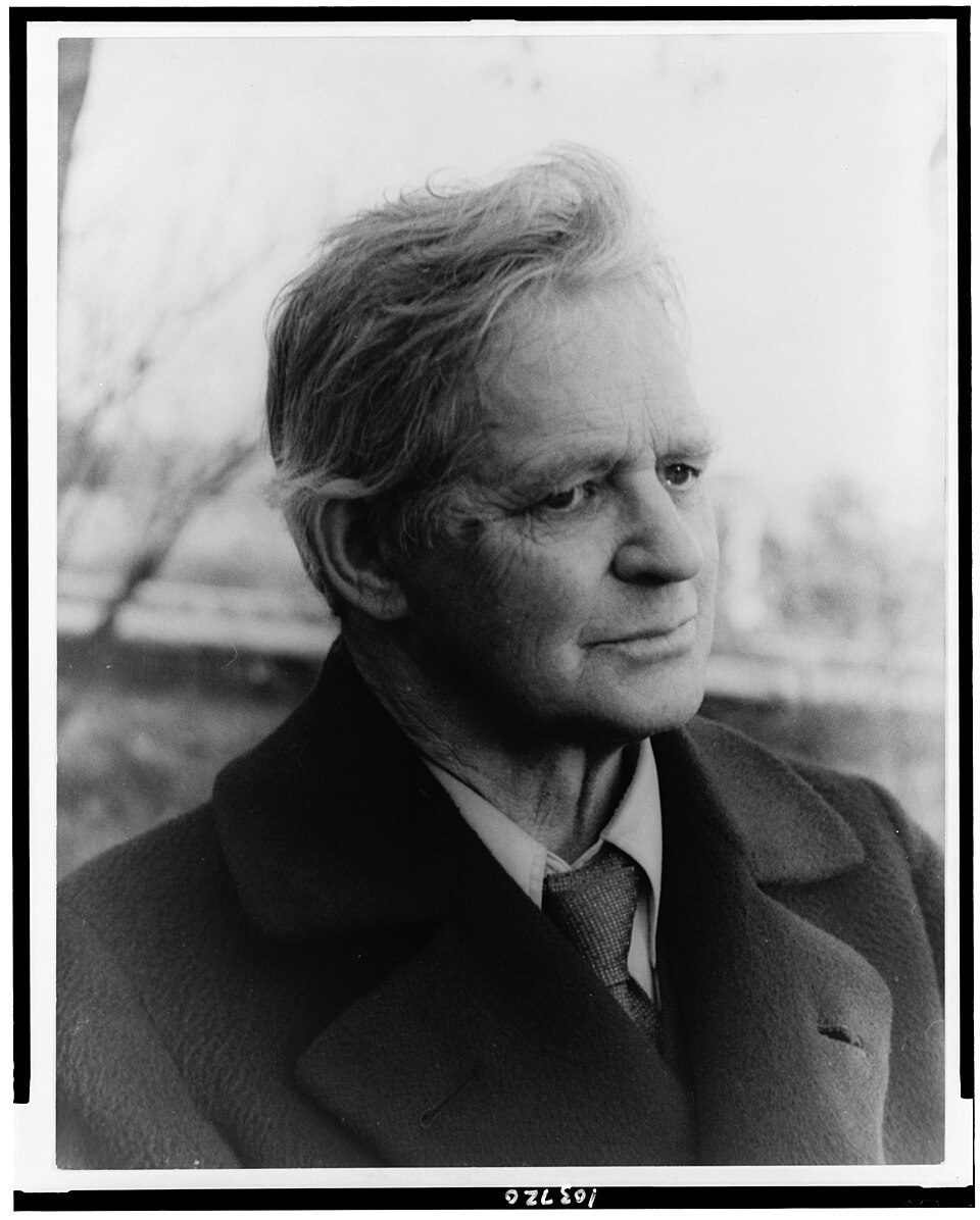 Black and white portrait of the sculptor George Grey Barnard in a heavy coat, looking to the side