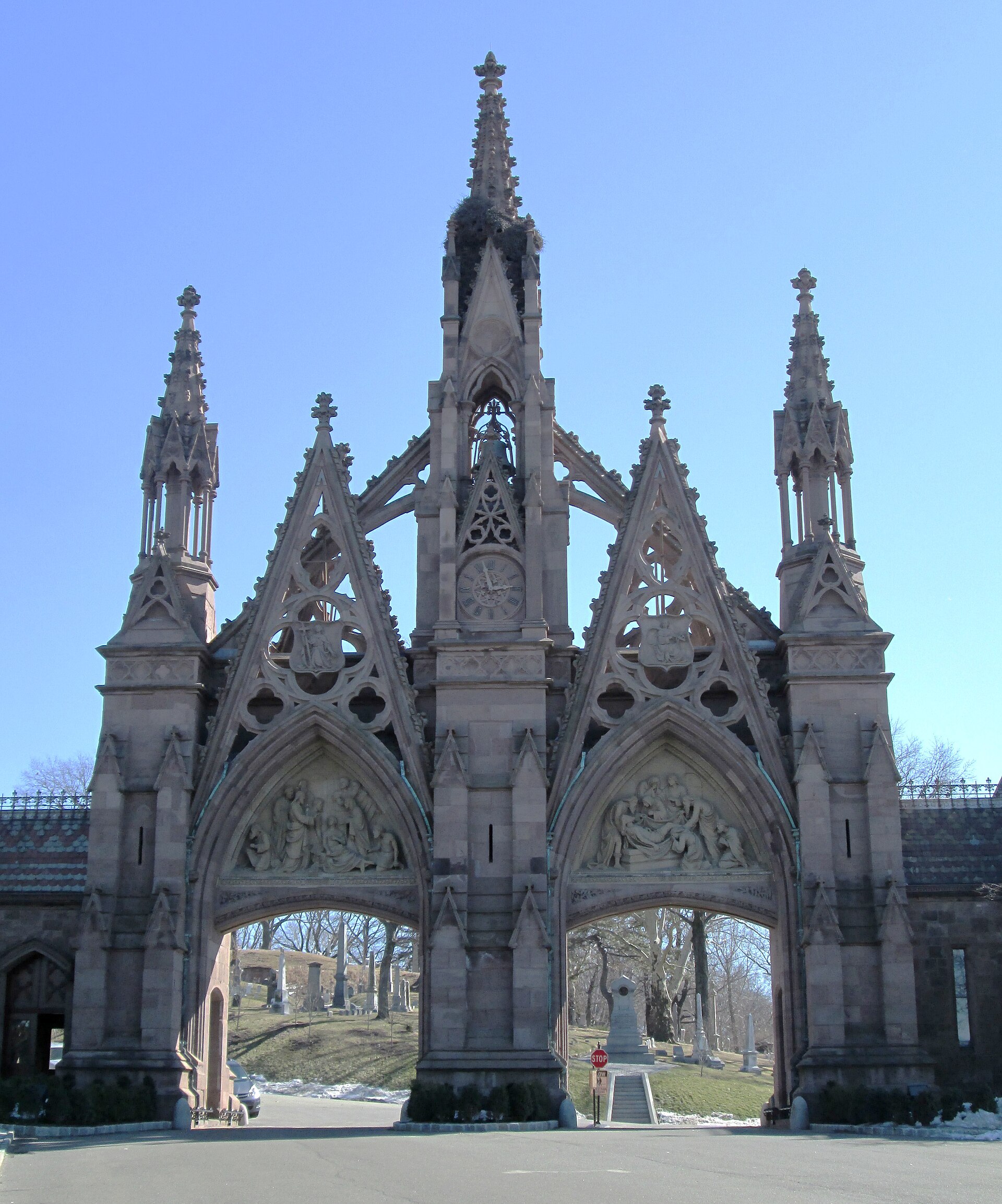 The Gothic Revival main gate of Green-Wood Cemetery, a brownstone arch with a central clock tower