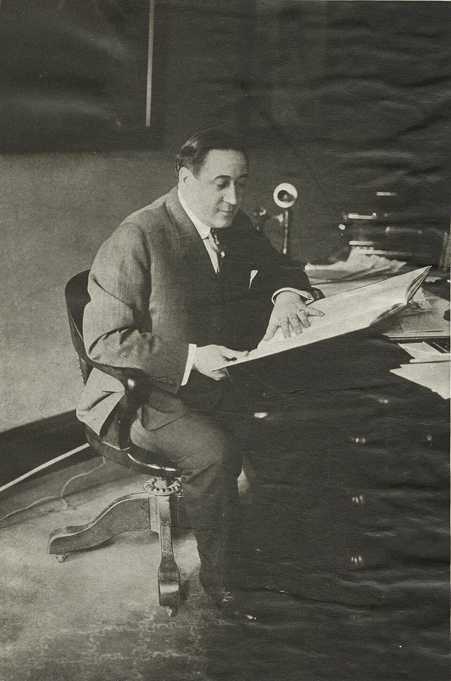 Theatrical producer Henry B. Harris at his desk in his office at the Hudson Theatre in New York, 1910