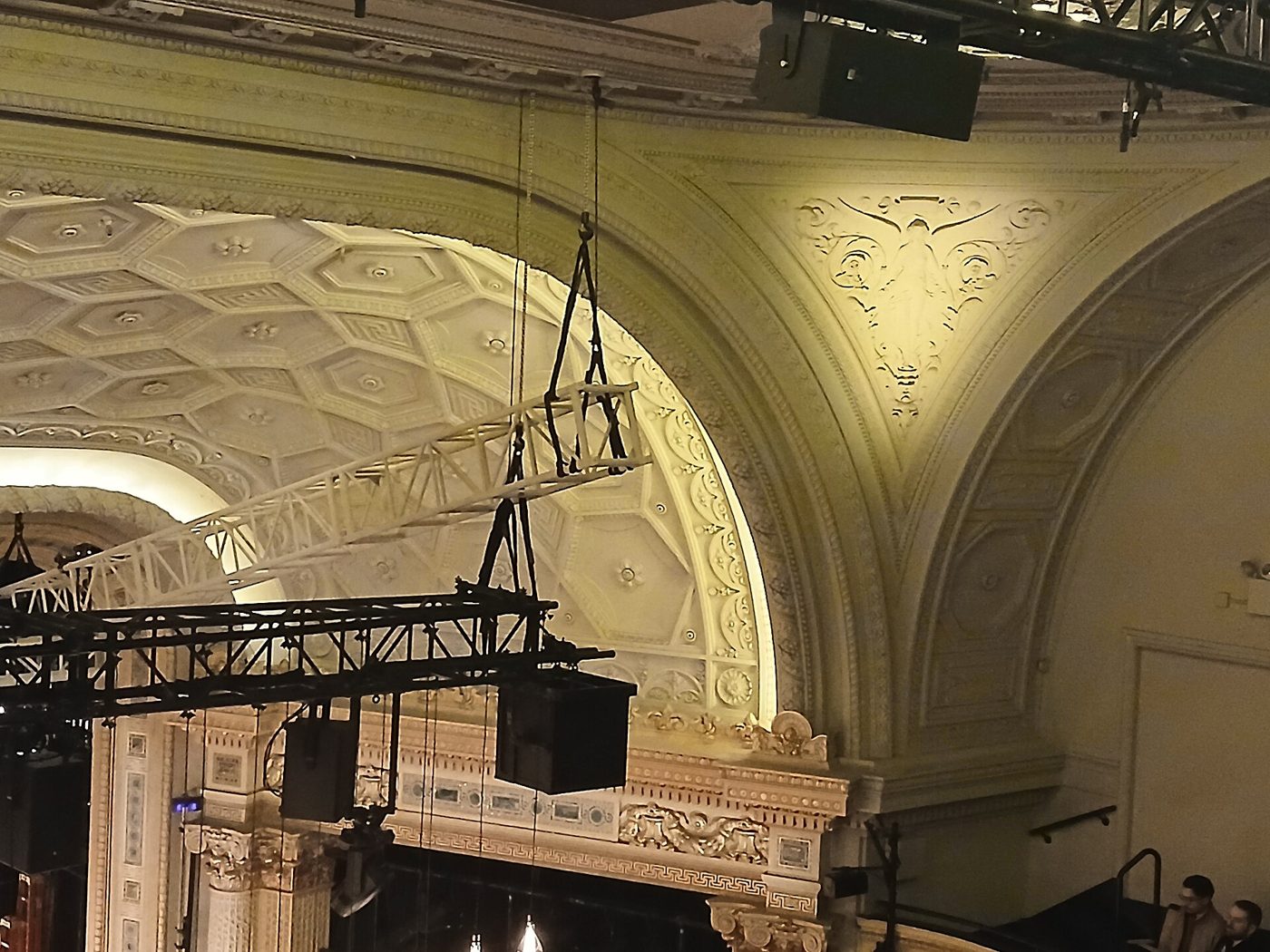 Plaster ceiling molding, a balcony front and stage lighting inside the Hudson Theatre in Manhattan, March 2026