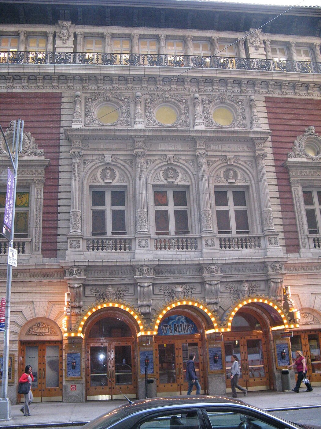 The ornate 43rd Street facade of the Lyric Theatre in Times Square, Manhattan, with arched doorways and brick and terra cotta