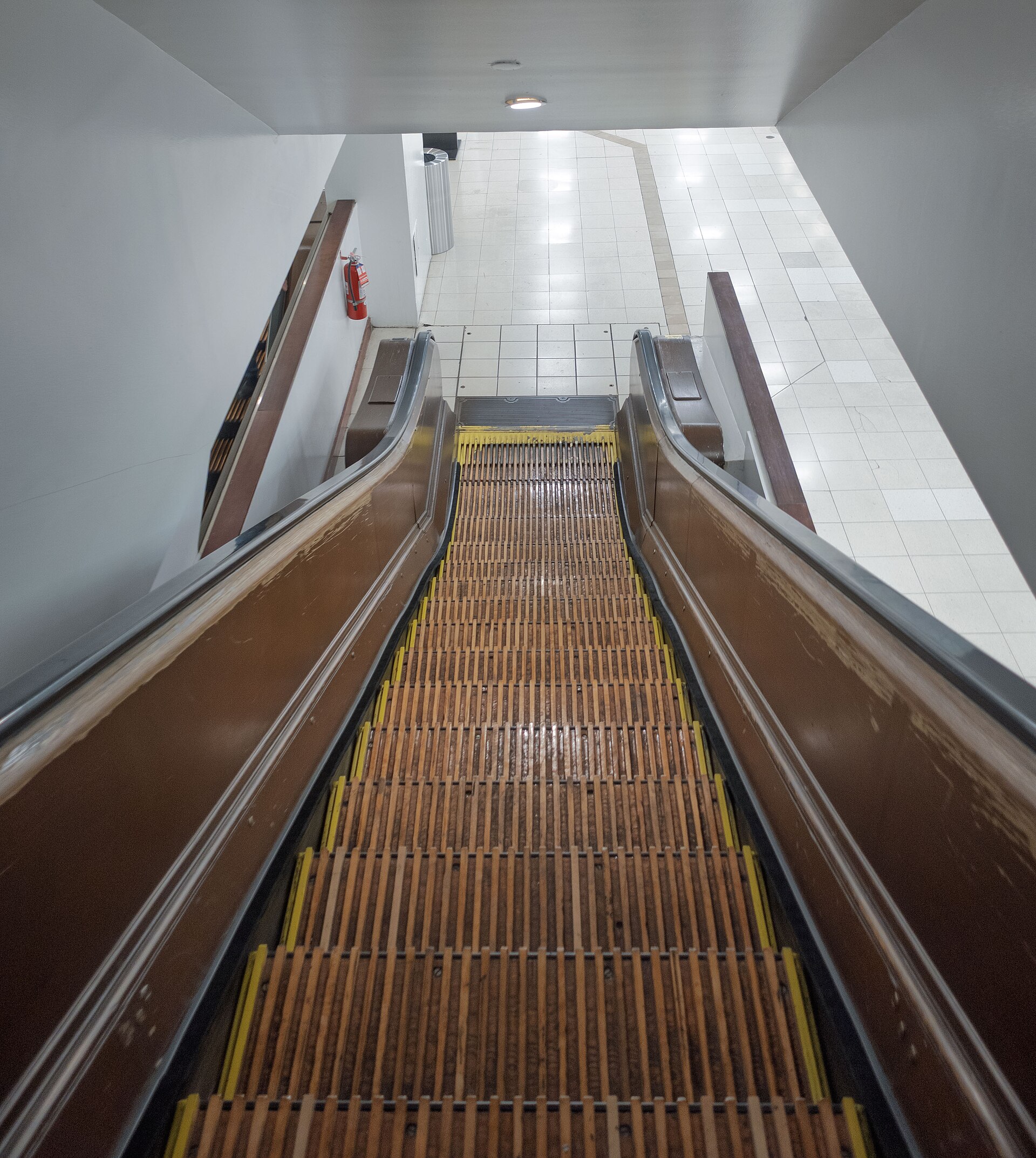 One of Macy's original wooden escalators, with worn oak steps and metal sides