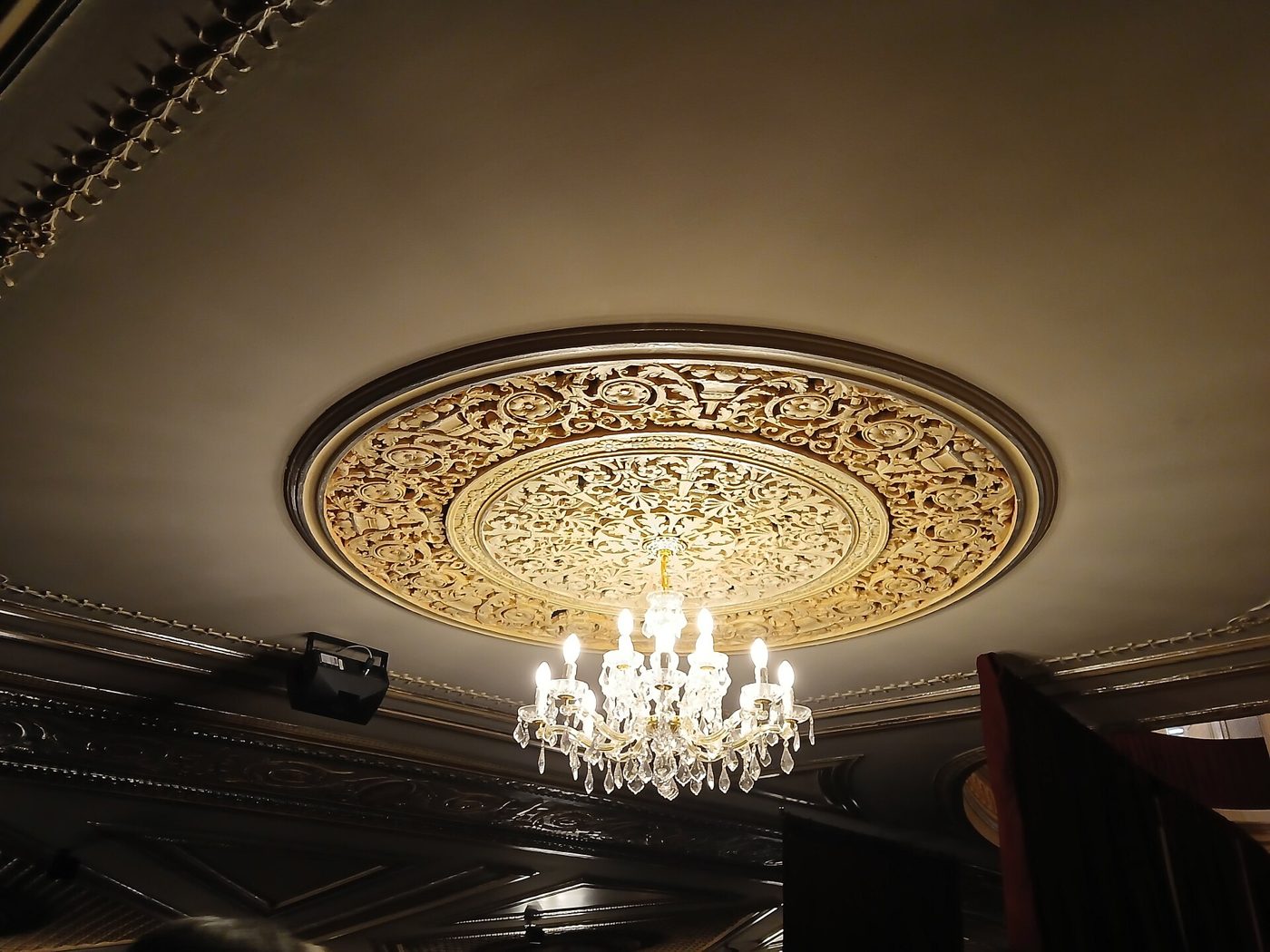 The plaster ceiling medallion and crystal chandelier inside the Majestic Theatre in Manhattan, April 2025