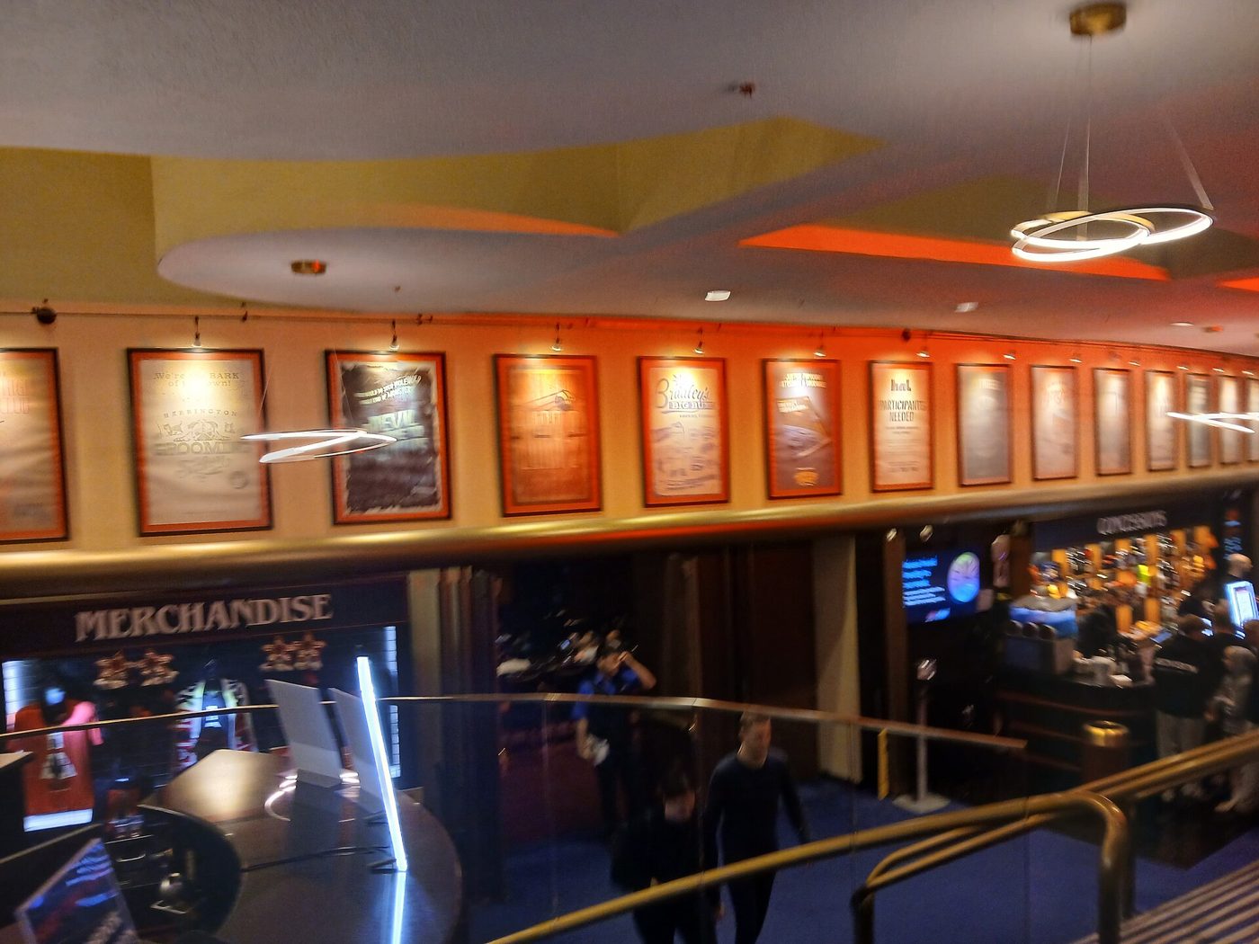 The lobby level of the Marquis Theatre in the Marriott Marquis in Manhattan with show posters and a merchandise stand, September 2025