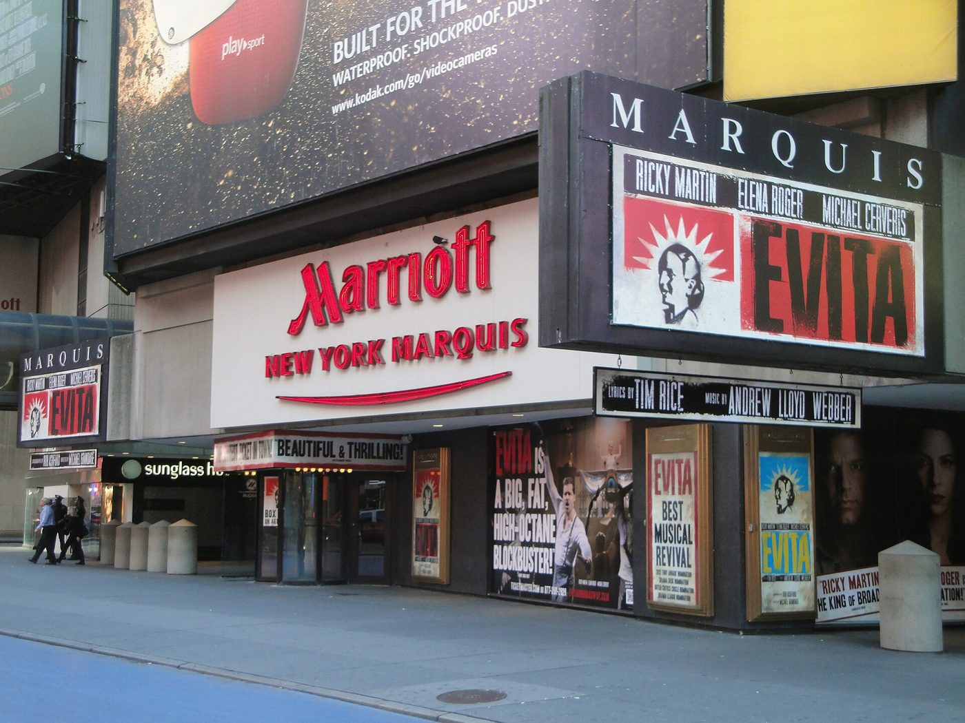 The Marquis Theatre entrance and marquee beside the Marriott sign on Broadway in Manhattan with an Evita sign, 2012