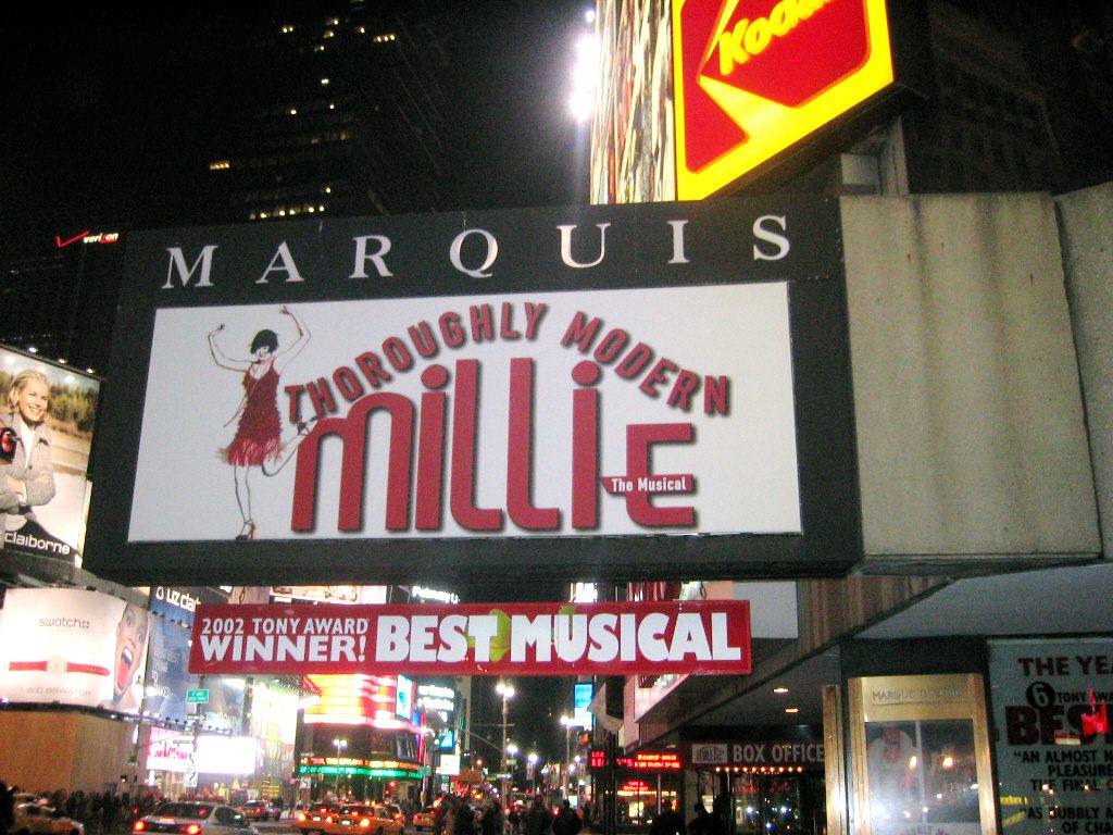 The Marquis Theatre marquee for Thoroughly Modern Millie at night in Times Square, Manhattan, 2003