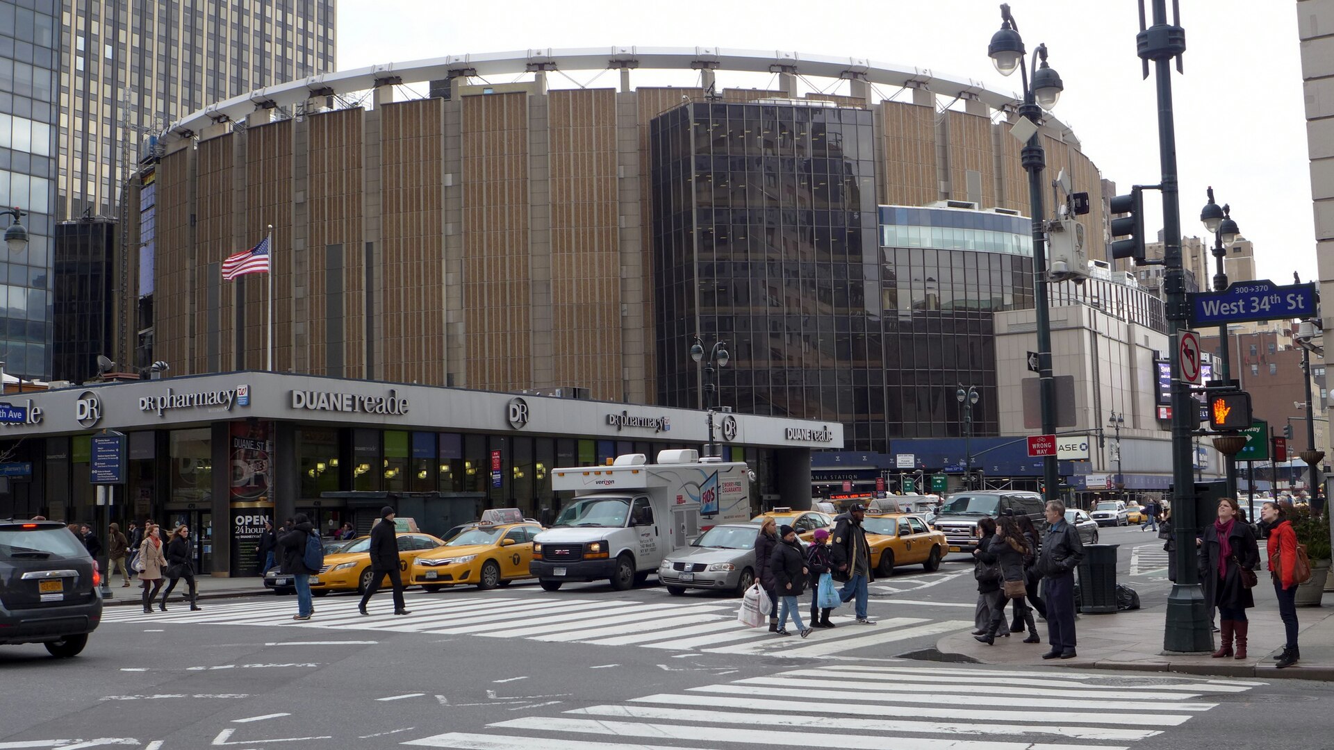 The exterior of the current Madison Square Garden, a round concrete arena with vertical fins, seen from Seventh Avenue in February 2013