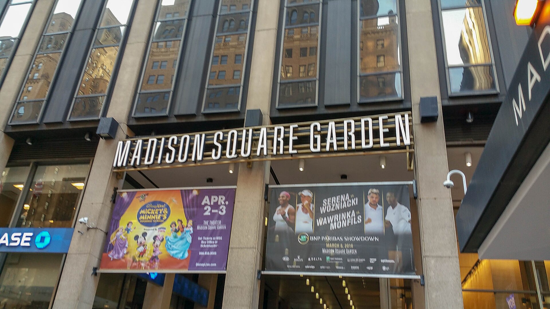 The front entrance of Madison Square Garden on Seventh Avenue, with its marquee and glass doors under the round arena wall