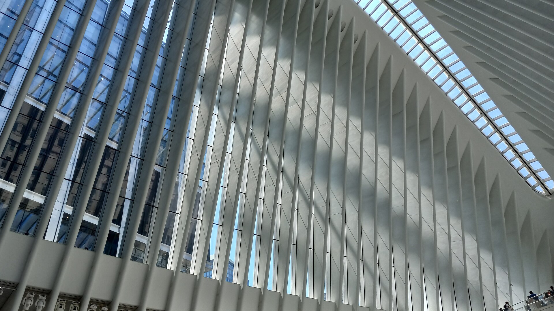 The interior of the Oculus, a tall white ribbed hall with a skylight running its length