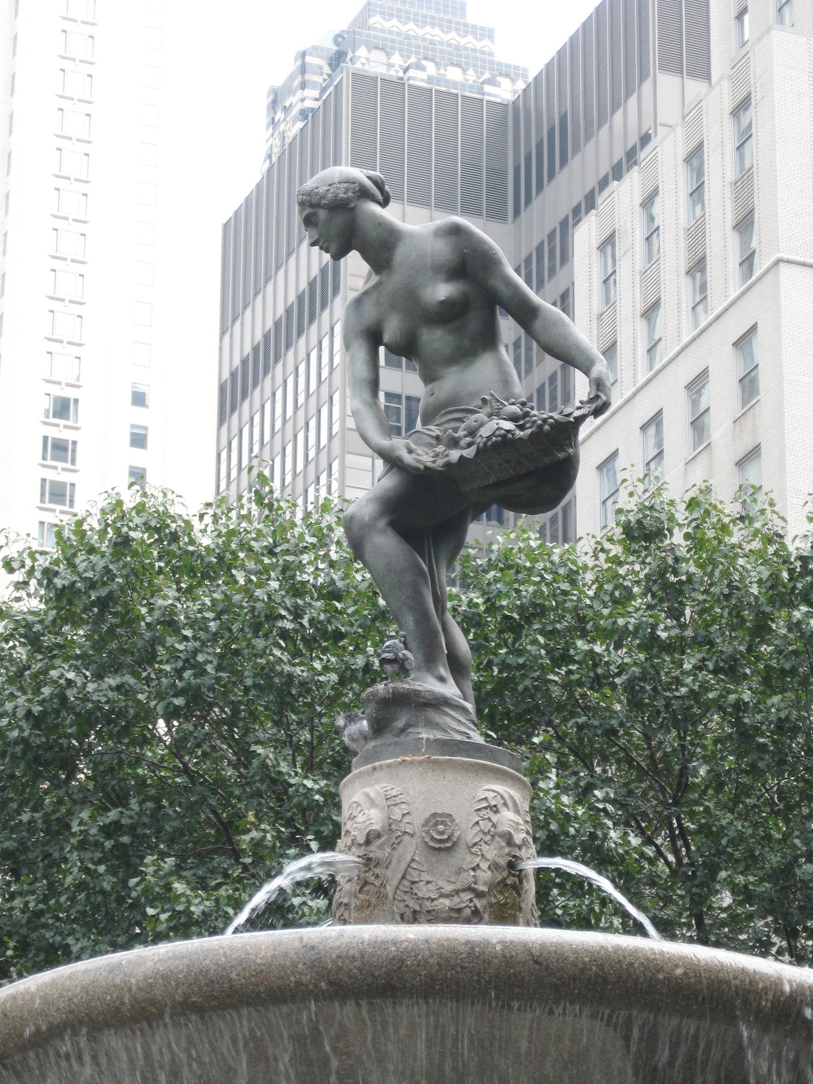 The Pomona statue on the Pulitzer Fountain with the Plaza Hotel behind it.