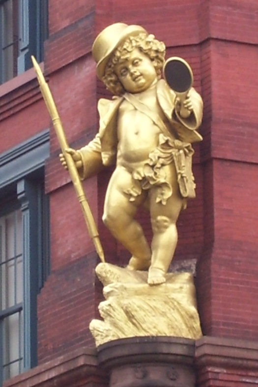 The gilded statue of Puck at the corner of the Puck Building.