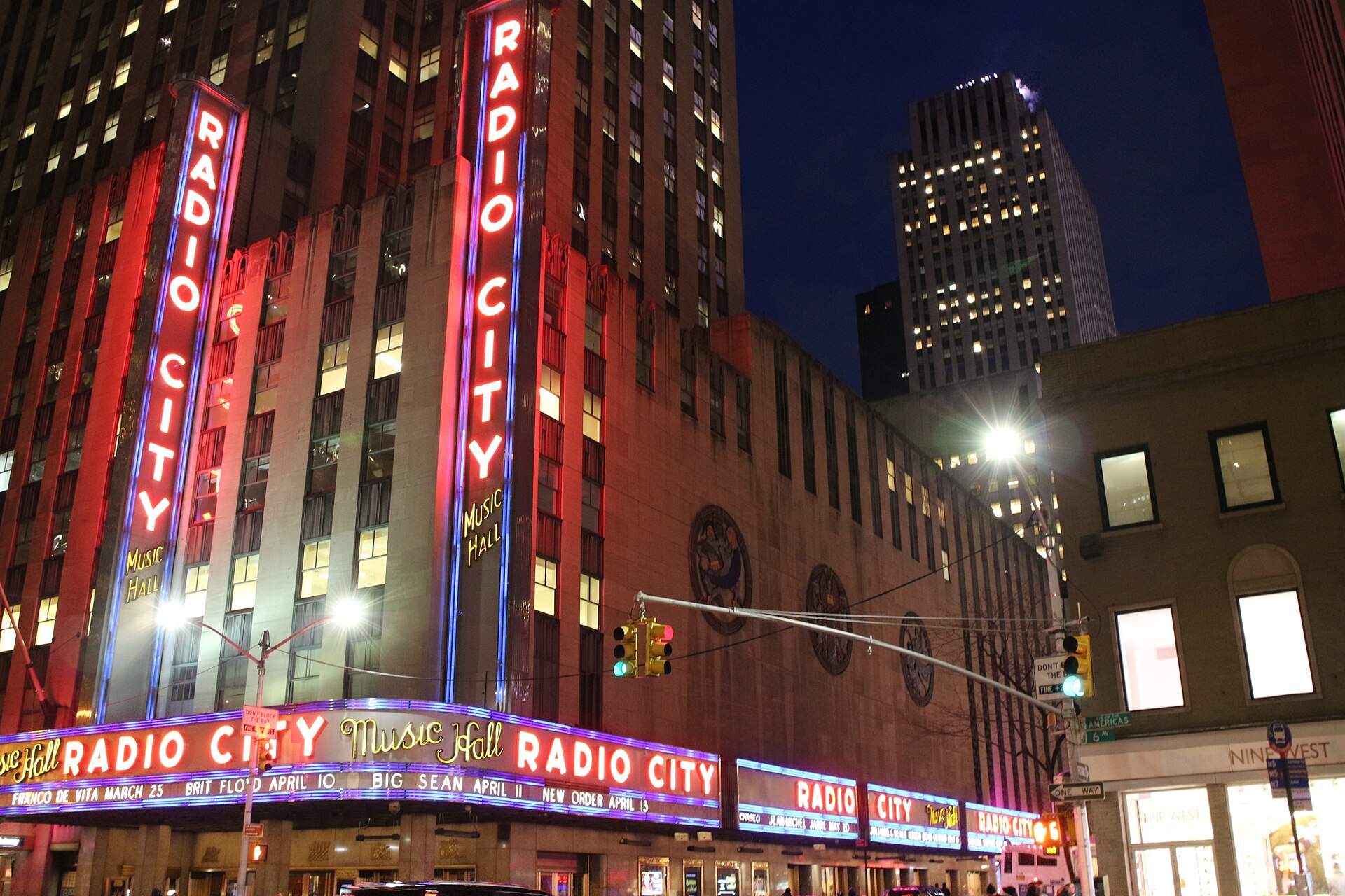 The Radio City Music Hall marquee and vertical sign at night