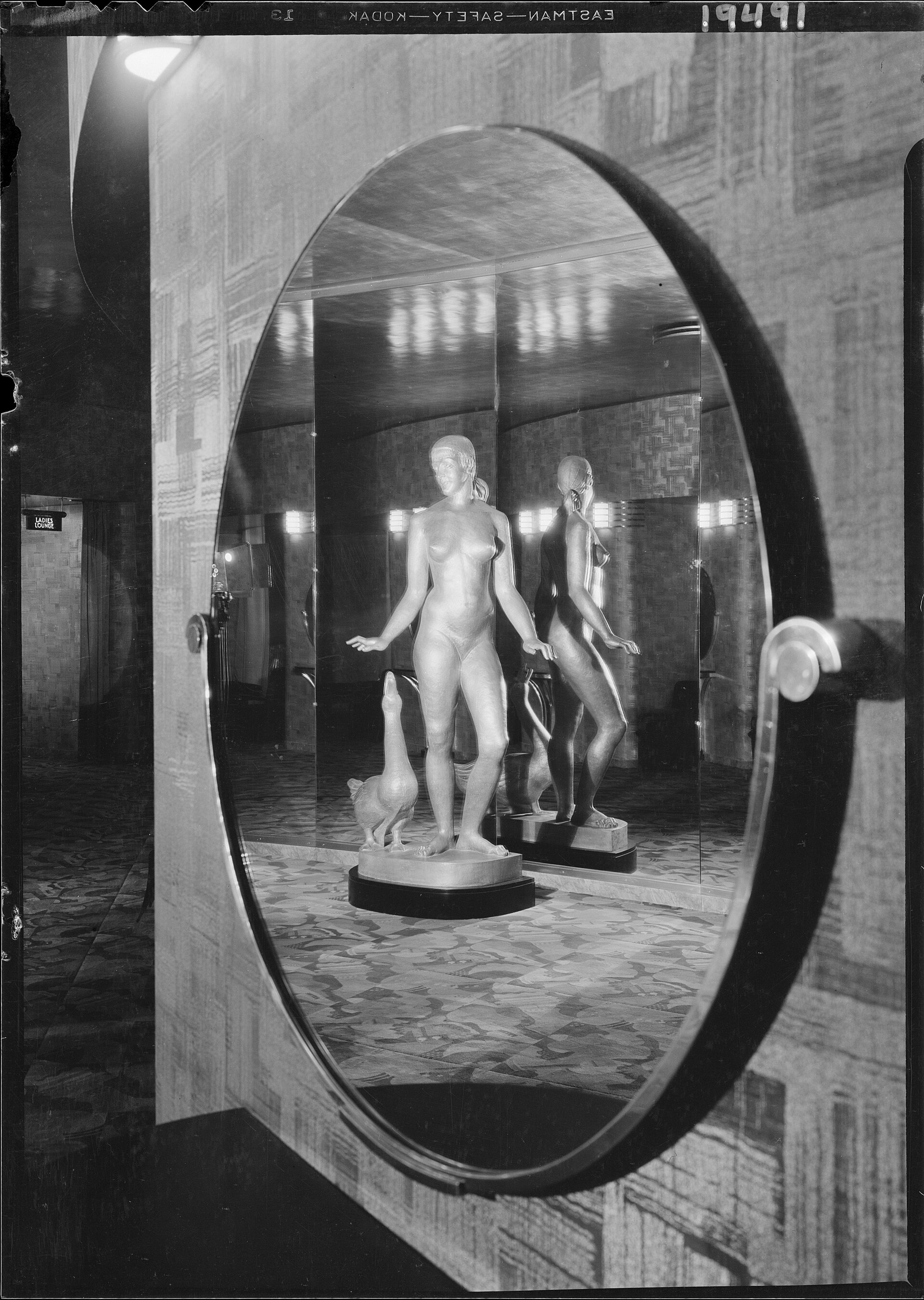 Statues seen through a large round opening inside the International Music Hall in 1932