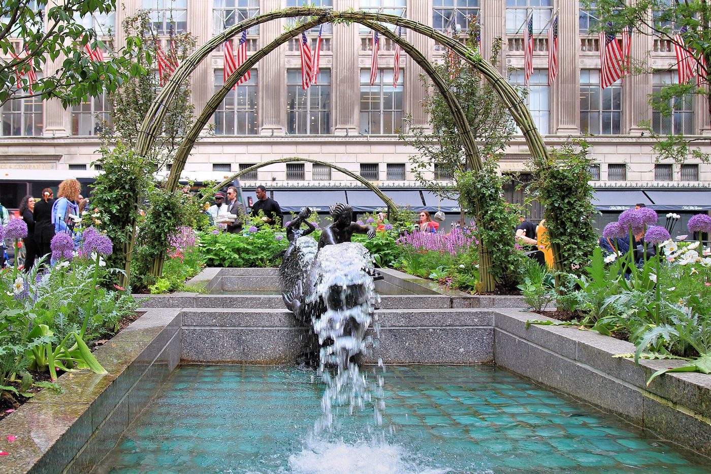 The Channel Gardens at Rockefeller Center with a fountain and flower beds leading toward the buildings