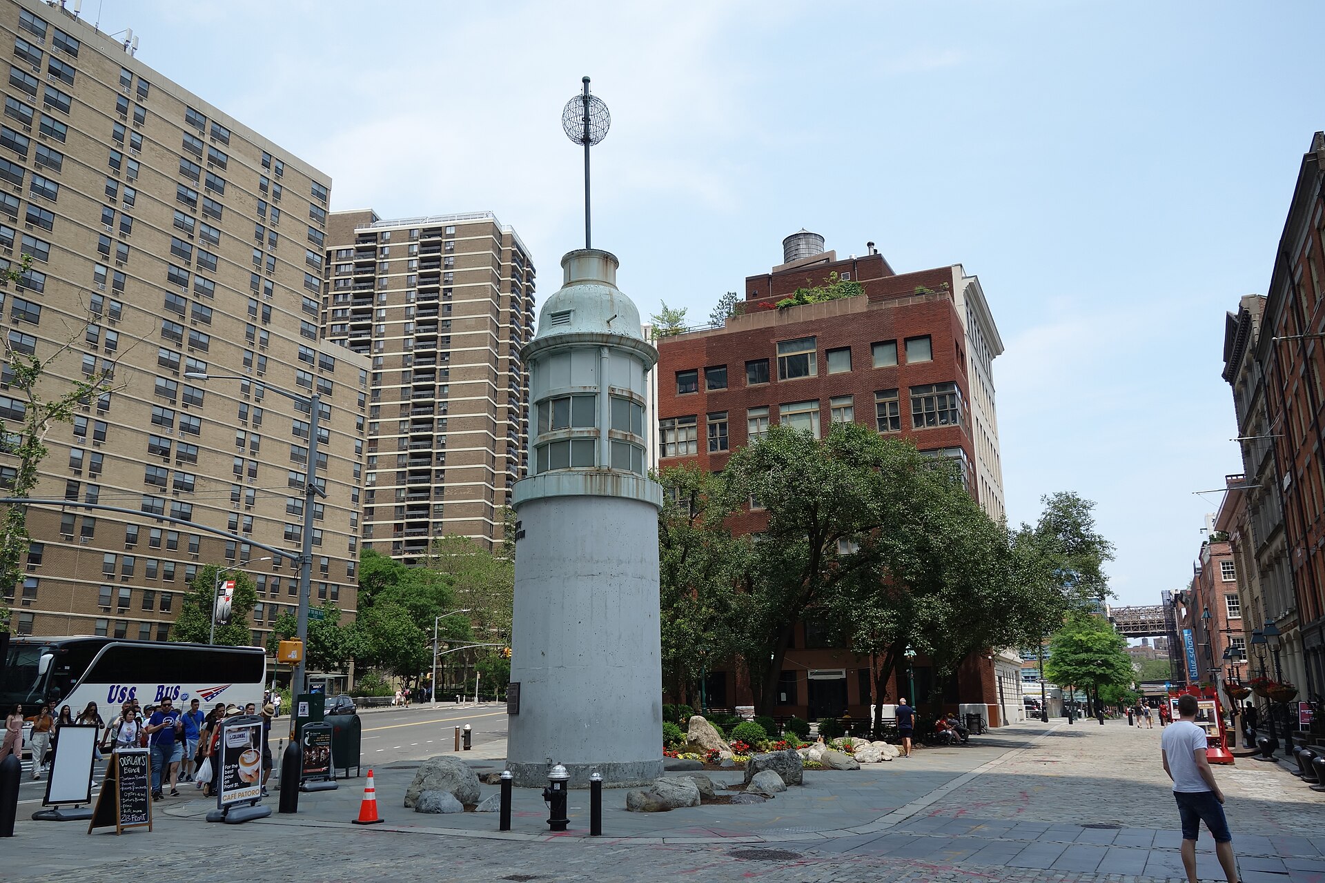 The Titanic Memorial Lighthouse, a white tower with a time ball on top, standing in a small paved park