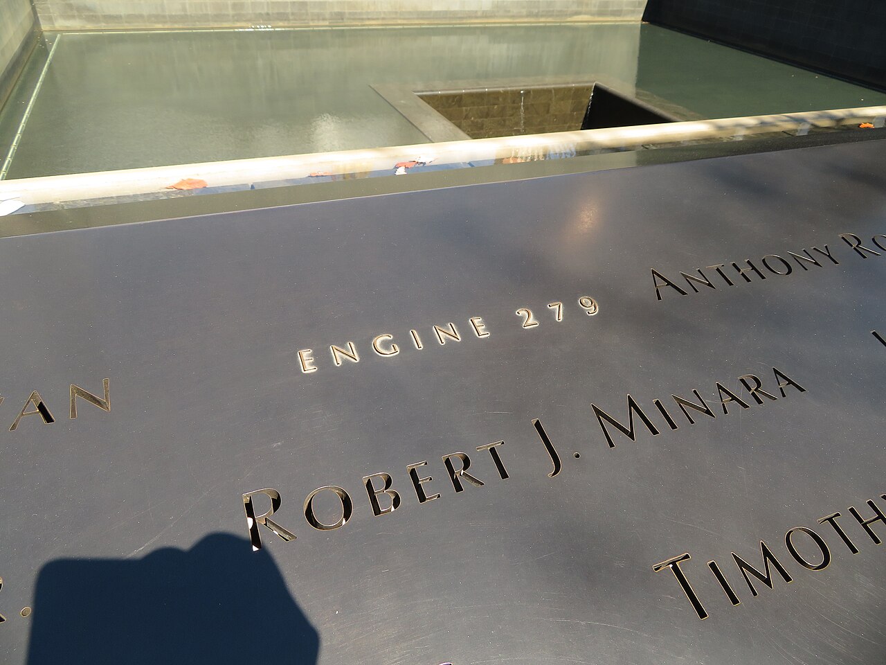 Close view of the bronze parapet with incised names, including the grouping Engine 279