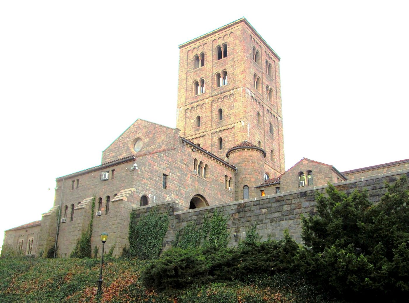 The four-story stone tower of The Cloisters rising above the museum's walls and roofs in Fort Tryon Park