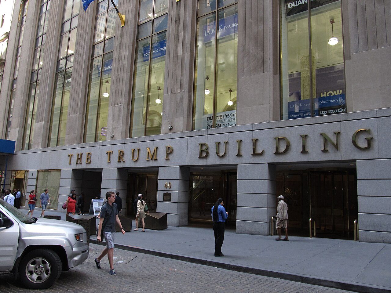 The Trump Building entrance at 40 Wall Street with its limestone base in the Financial District