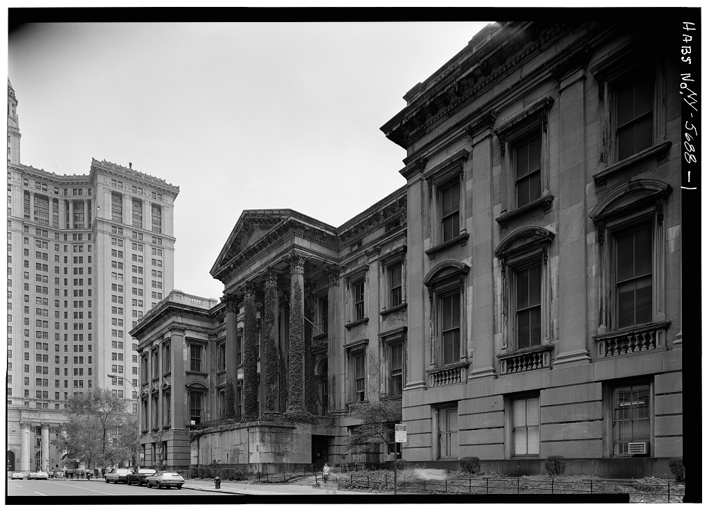 The Tweed Courthouse photographed by the Historic American Buildings Survey, its portico covered in ivy before restoration.