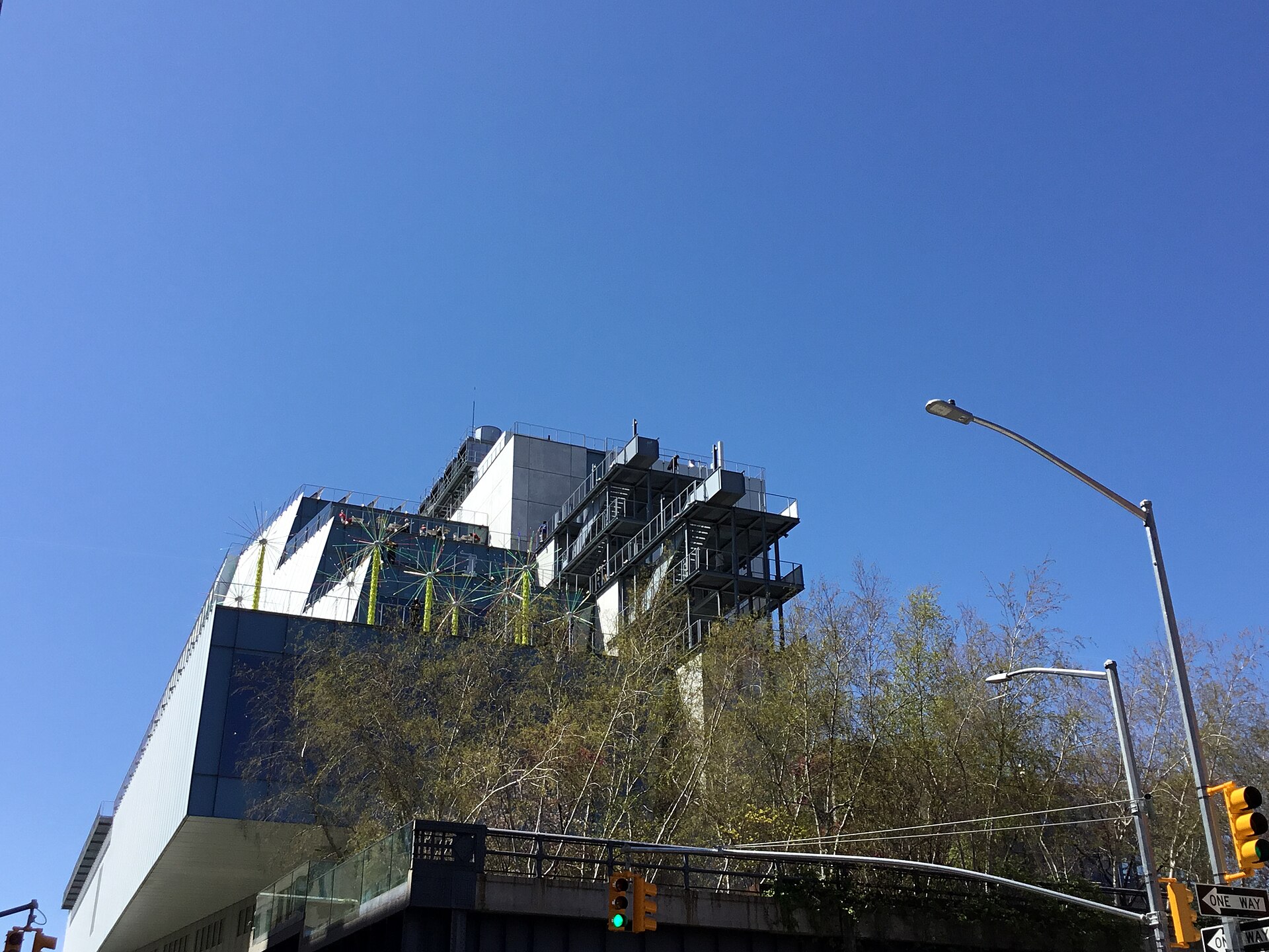 The Whitney Museum's Renzo Piano building at 99 Gansevoort Street, an asymmetrical pale blue steel and glass building with stepped outdoor terraces