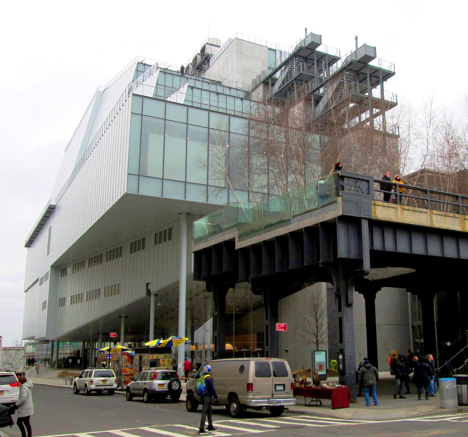 The Whitney Museum seen beside the southern end of the High Line, with the elevated park's plantings in the foreground